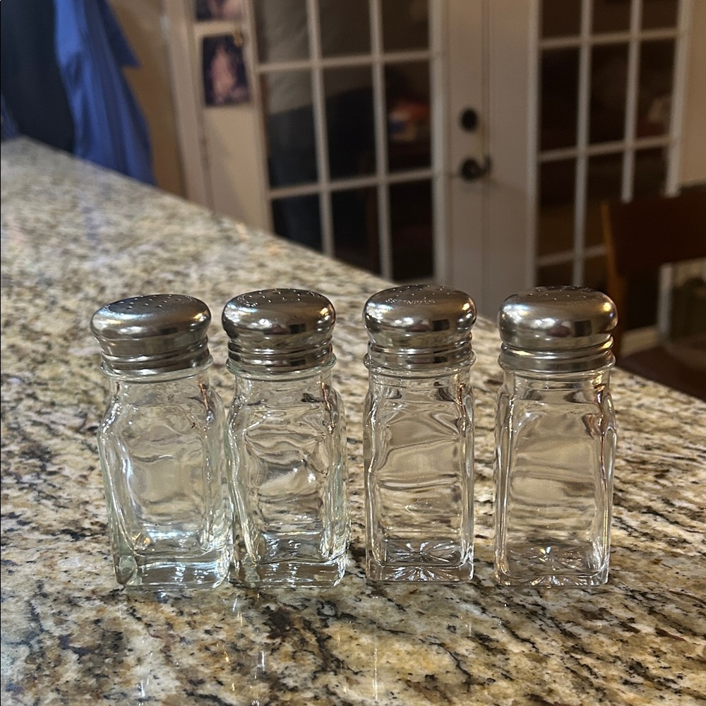 Set of Four Glass Shakers with Silver Tops